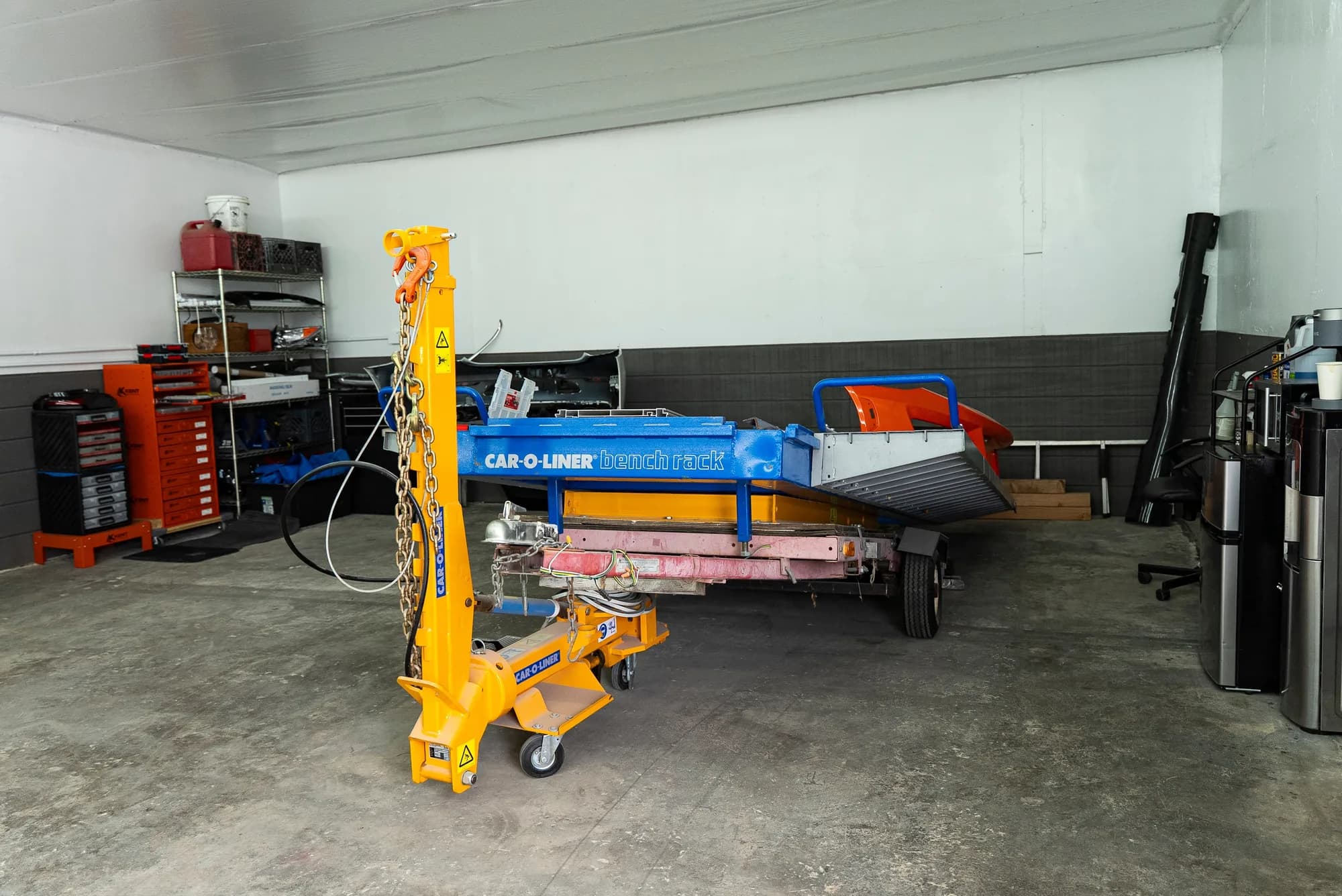 A Car-O-Liner bench rack with body panels removed during disassembly and blueprinting
